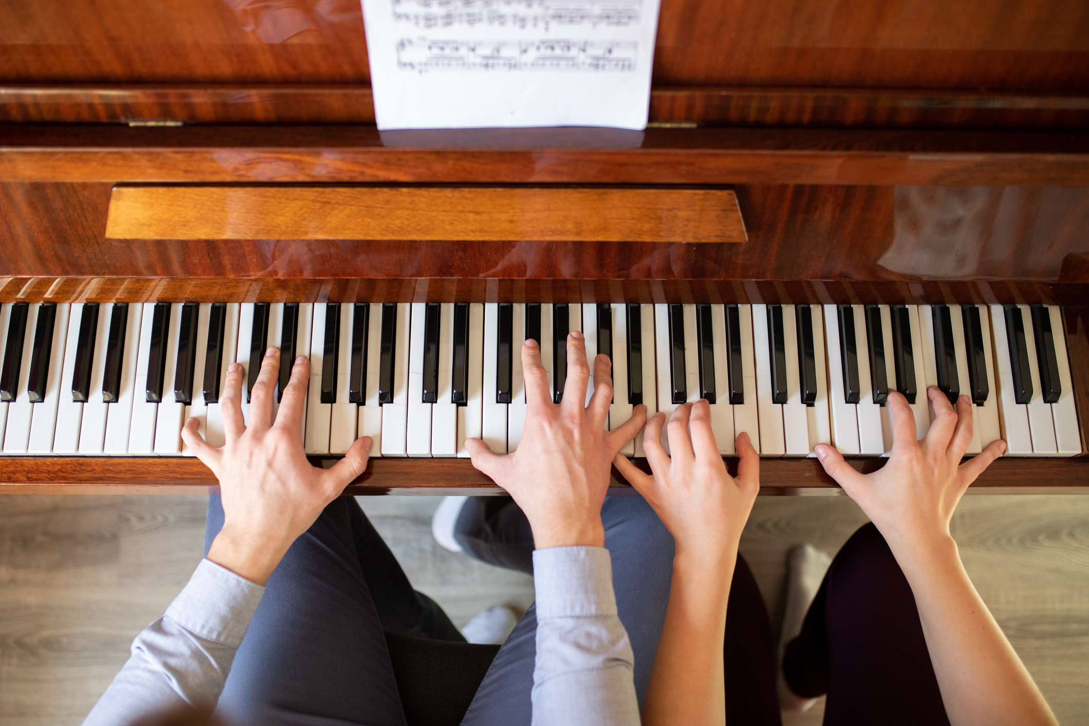 Siblings playing piano together
