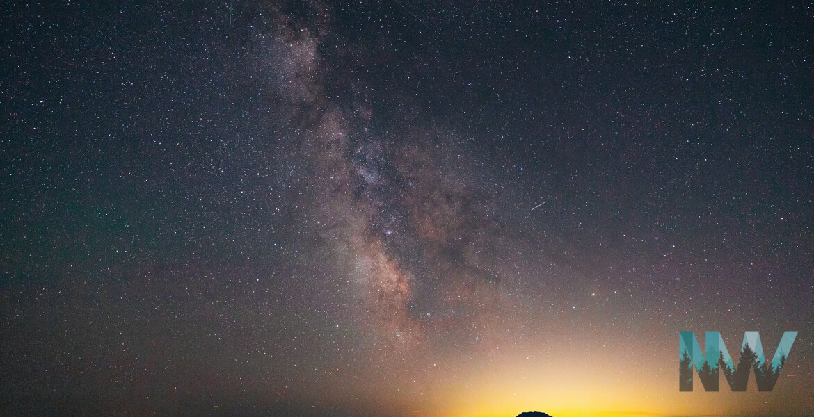 The Milky Way over Mt. Saint Helens as the distant city lights illuminate the horizon.