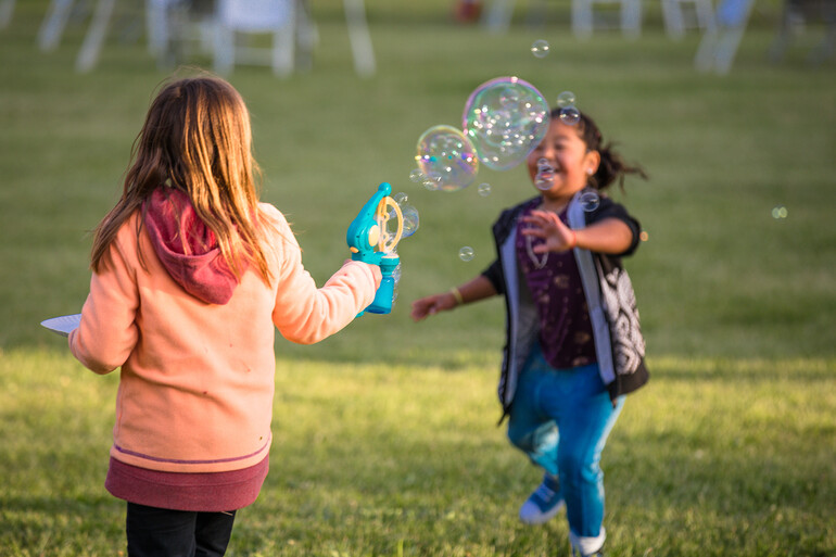 Young girls playing with bubbles