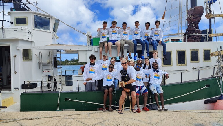 young people pose for group photo on boat
