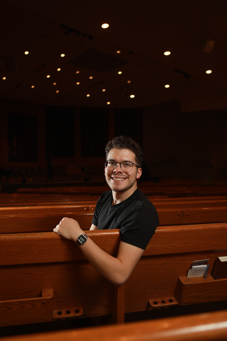Portrait of Isaac Peterson among church pews.