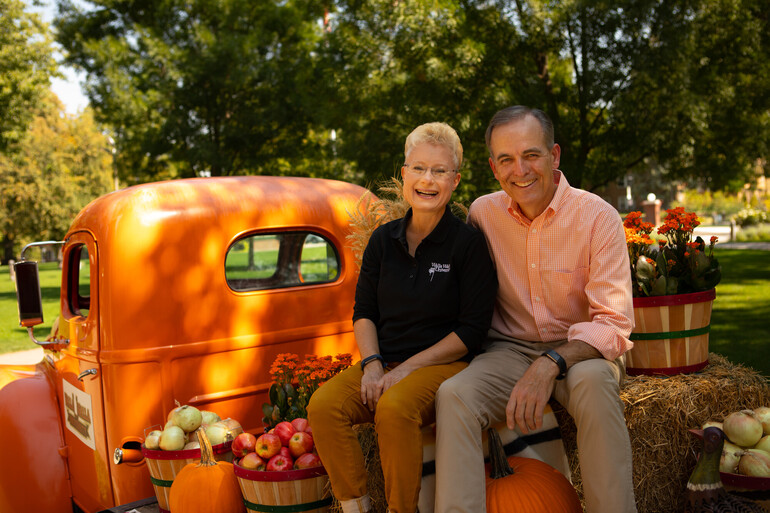 John and Pam McVay sit on truck decorated for fall.