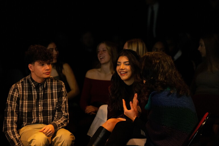 Students greet each other before a church service