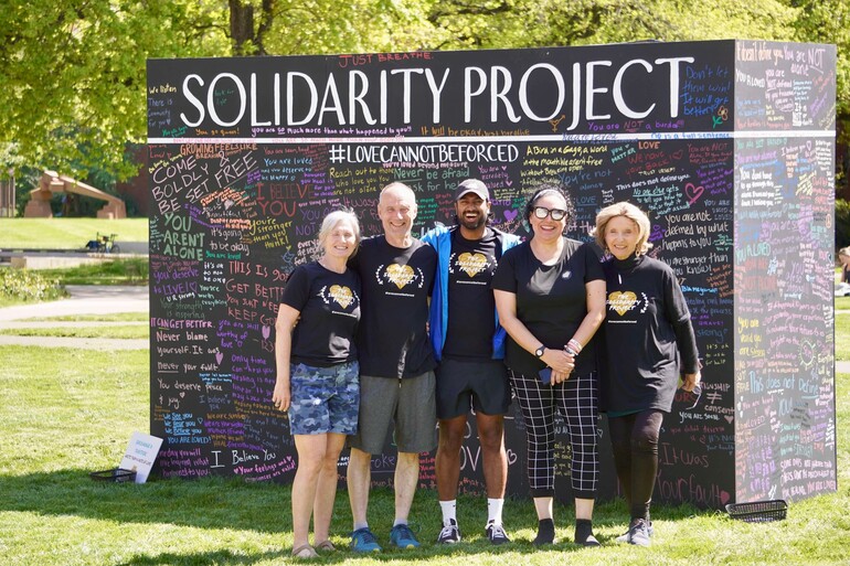 group in front of wall project