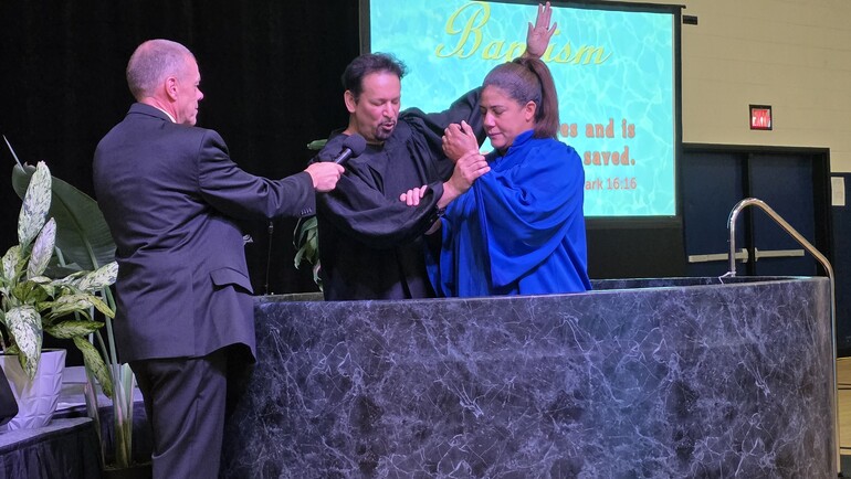 Pastor Marquez baptizes two ladies (mother & daughter) Angelanny Gonzalez (daughter – photo 1), Johanny  Gonzalez (mother – photo 2). This baptism took place during the Montana Conference’s Camp Meeting. Pastor Jim Jenkins, the president of the Montana Conference, is also in the photo.