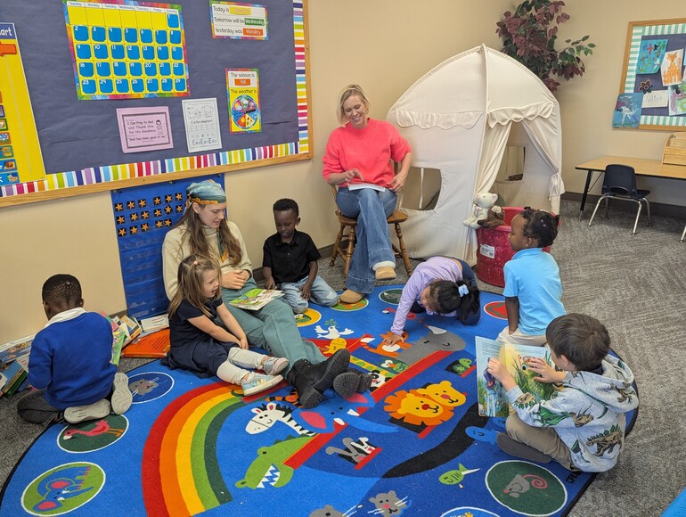 Students preparing for circle time with their teachers.
