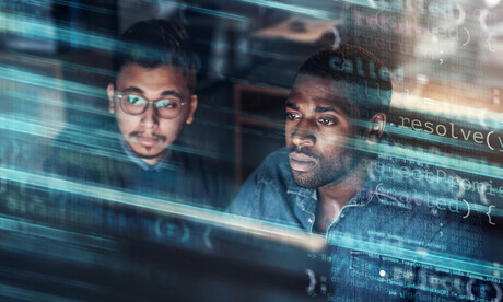 Two men looking at a computer.