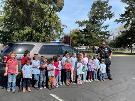 All Nations Center Adventurer Club takes a photo with a local police officer. 
