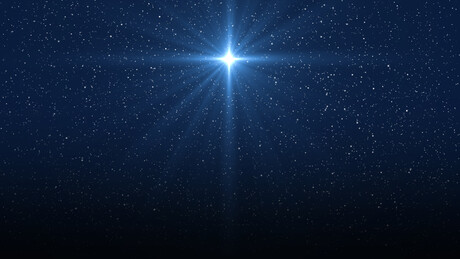 Christmas star of the Nativity of Bethlehem, Nativity of Jesus Christ. Background of the beautiful dark blue starry sky and bright star.