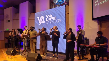 young adults singing on a stage