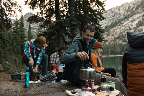 Students cook over campfire