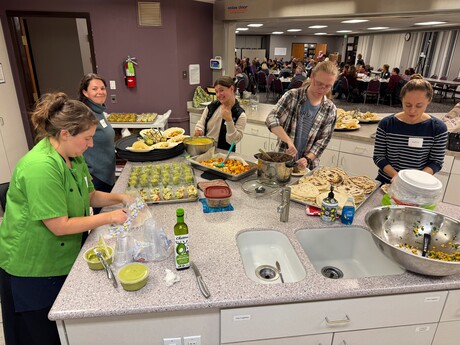 Volunteers prepare a healthy meal for Thursday night's presentation.