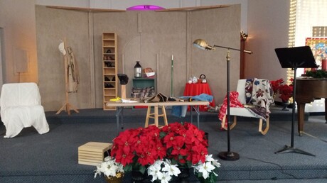 Set pieces and flowers adorn the stage of the Kennewick Seventh-day Adventist Church