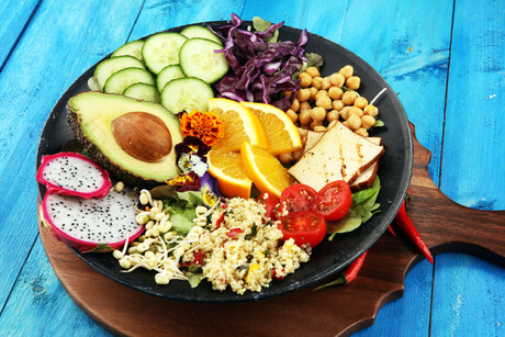 grilled tofu and dragon fruit buddha bowl with vegetable and humus.