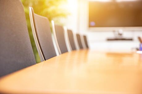 Morning light shines into the interior of an empty modern style conference room