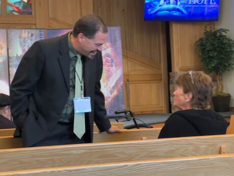 Pastor Chris Evenson greets guest