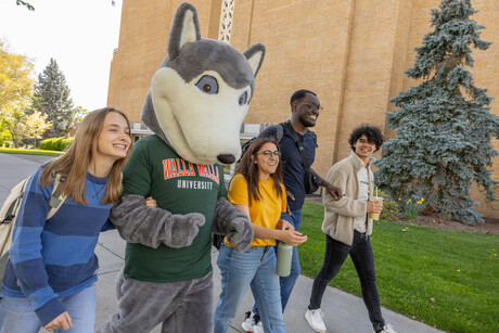 Walla Walla University students and mascot walking and laughing.