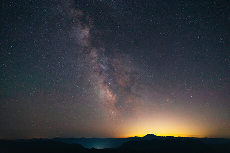 The Milky Way over Mt. Saint Helens as the distant city lights illuminate the horizon.