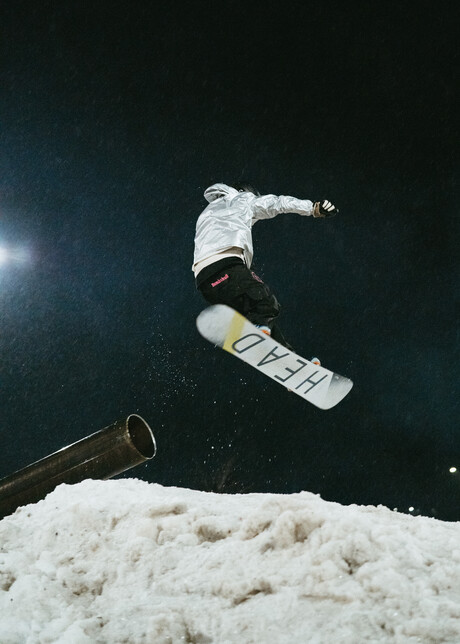A snowboarder mid-air after a jump