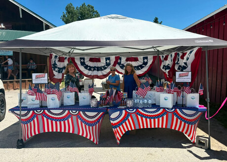 From left to right: Chery Casey, Garden Valley Church secretary; Marge Van Dyk, Garden Valley Church head deaconess; and Peggy Lucht Garden Valley Church personal ministries leader, man the church’s booth in Crouch, Idaho, on the Fourth of July.