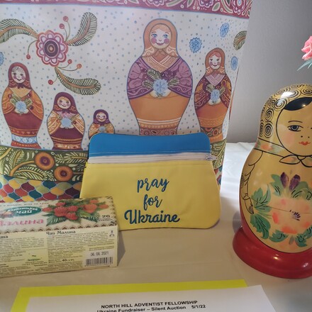 A silent auction display encouraging people to pray for Ukraine.