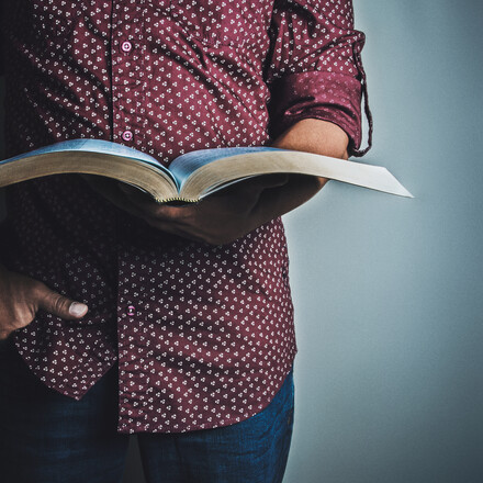 Man holds a Bible.