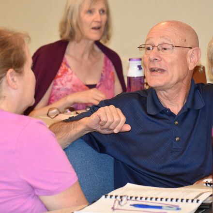 Norval Rios shares with another attendee.