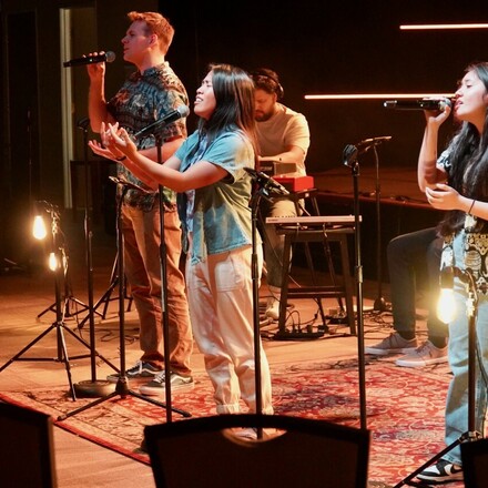 Three students sing for church.