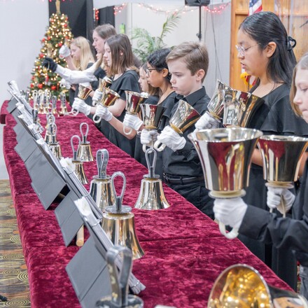 Students play handbells for a concert