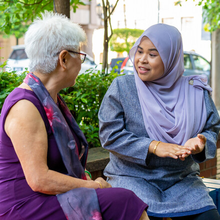 Multi-racial friends having a heart to heart conversation outdoors.