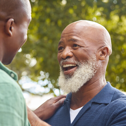 Father and son laughing outdoors
