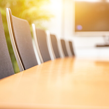 Morning light shines into the interior of an empty modern style conference room