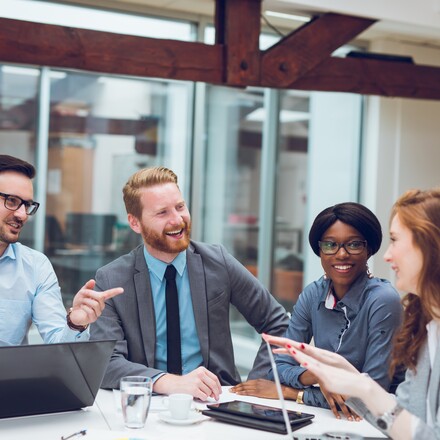 Image of business partners discussing documents and ideas during business meeting.