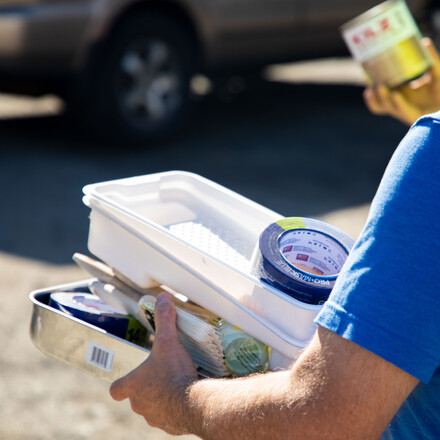 A man holding painting materials
