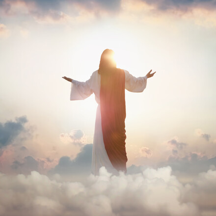 The resurrected Jesus Christ ascending to heaven above the bright light sky and clouds and God, Heaven and Second Coming concept