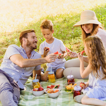 Enjoying Picnic Basket fruits on a sunny summer day in nature