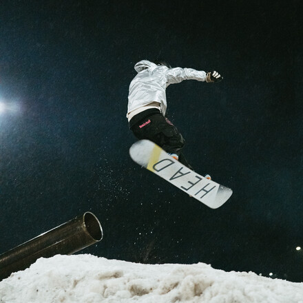 A snowboarder mid-air after a jump