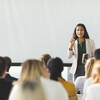 A woman speaks to a group of people