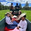 Color of Threads actors on set in a wagon.