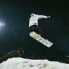 A snowboarder mid-air after a jump