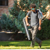 Grounds worker student using a leaf blower