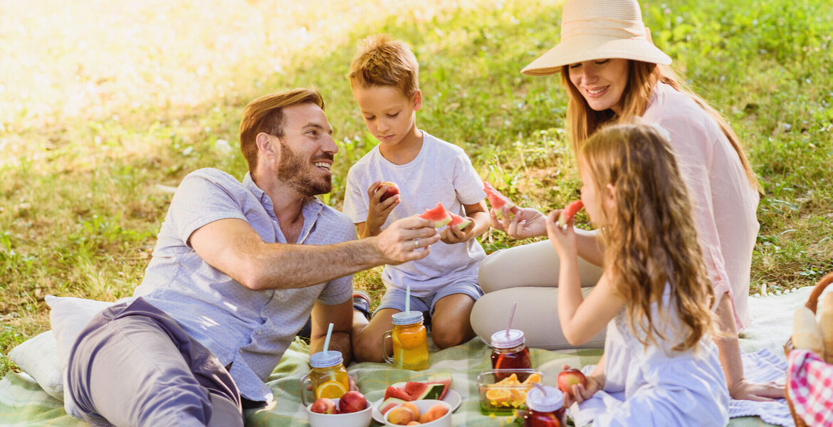 Enjoying Picnic Basket fruits on a sunny summer day in nature