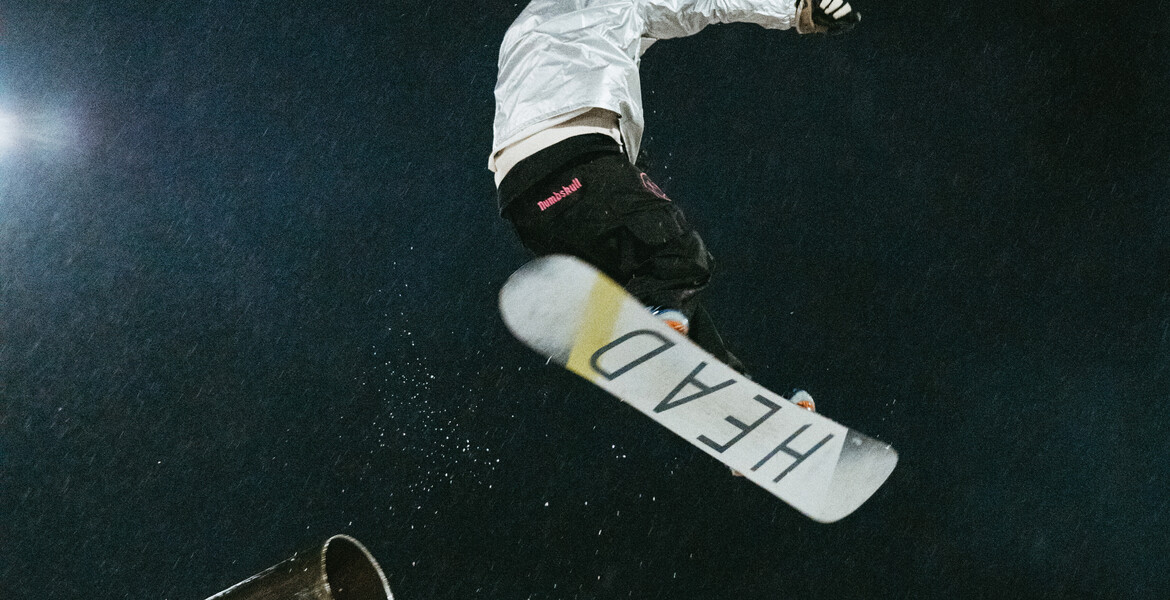 A snowboarder mid-air after a jump